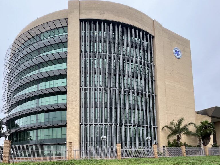 The picture depicts the SADC Headquarters. Large building from sanstone with big windows and the SADC logo on its right side.